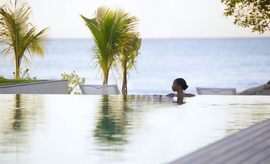A woman relaxing in an infiniti pool at Silversands Resort in Grenada.