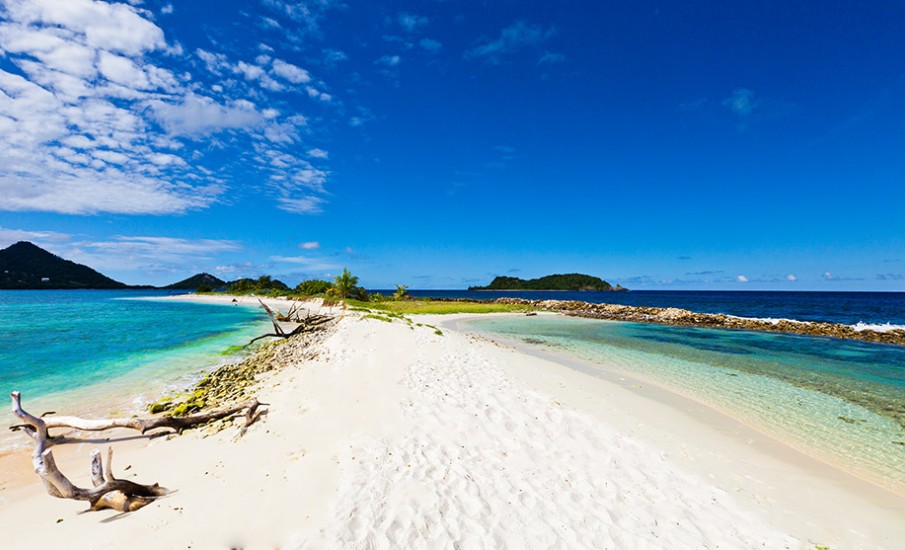 a beach with blue water and a sandy beach