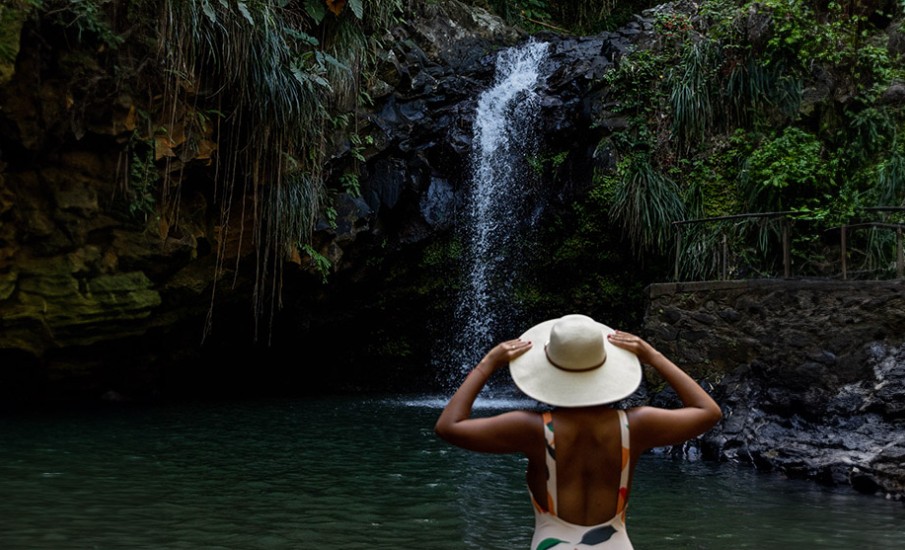 a person standing in front of a waterfall