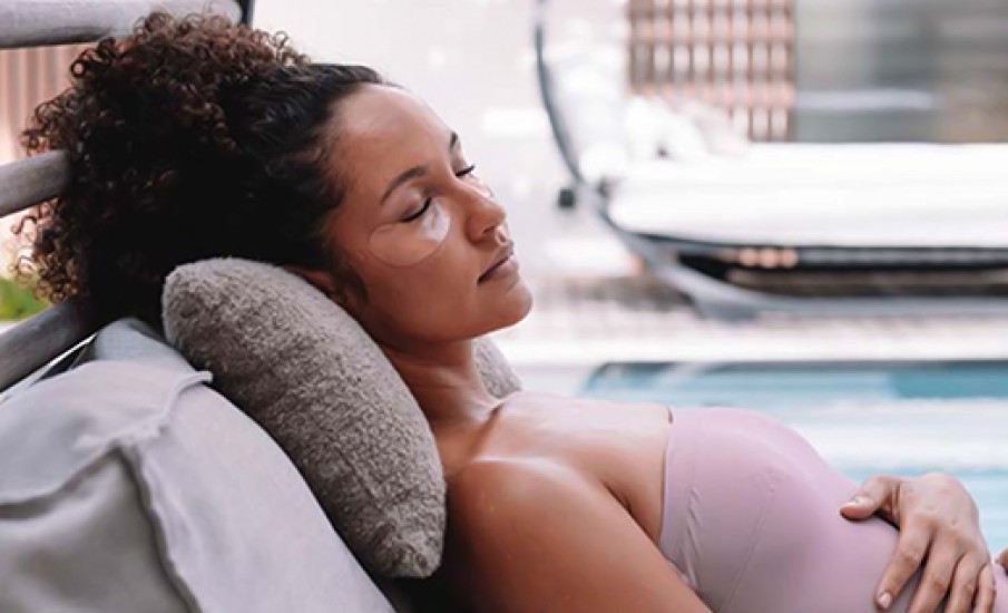 a woman lying on a couch with her eyes closed