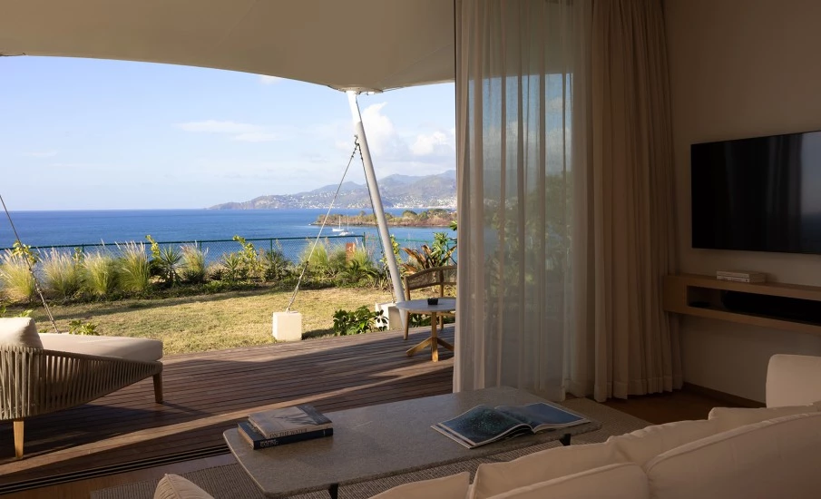a living room with a view of the ocean and a boat