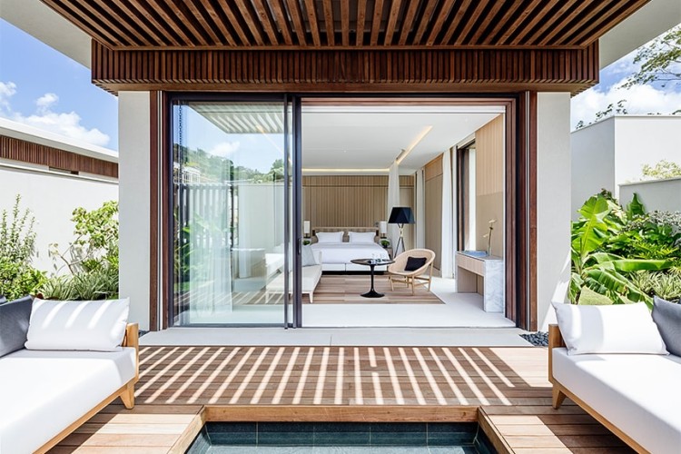 A villa bedroom with a sliding glass door leading to a private plunge pool at Silversands Grand Anse.