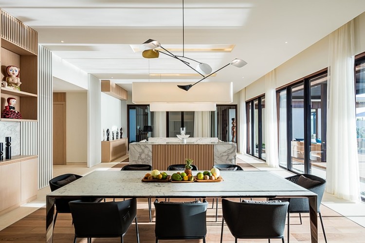 Interior of a luxury Grand Anse villa dining room showing a table topped with fresh fruit.