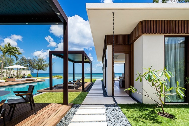 A stone walkway next to a pool at Silverdands Grand Anse.