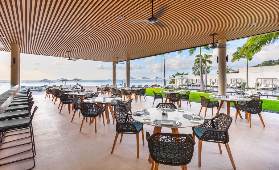 Wide angle view of the outdoor dining area at Grenadian Grill at Silversands Grenada Resort.
