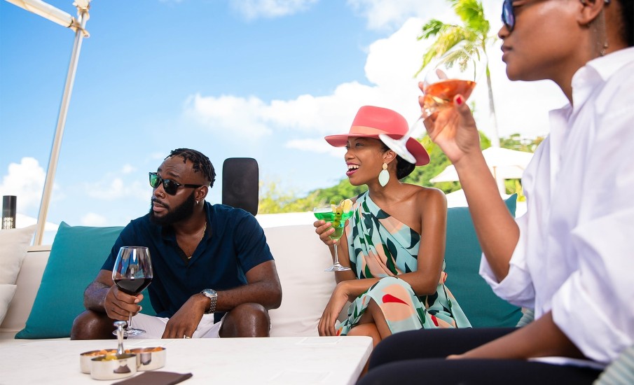 Friends sipping cocktails from a rooftop bar in Grenada.