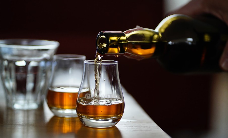 Rum being poured into a glass at Puro Bar and lounge in Grand Anse Grenada.