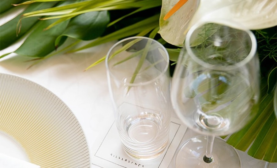 A glass cup on a decorated table.