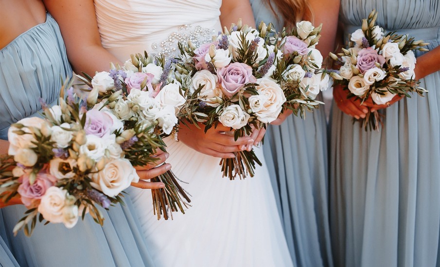 Bridal party holding their bouquet of flowers.