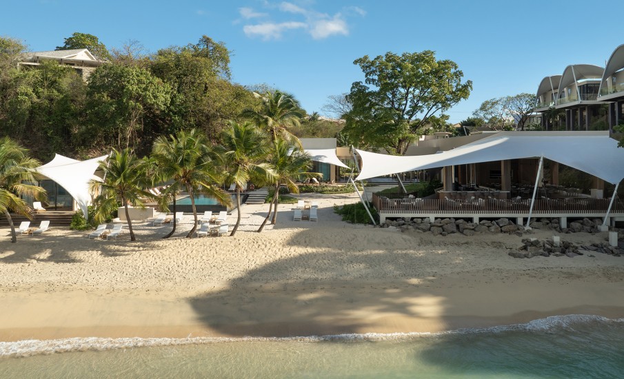 White sand beaches dotted with lounge chairs at the beach resort in Grenada, Silversands Beach House.