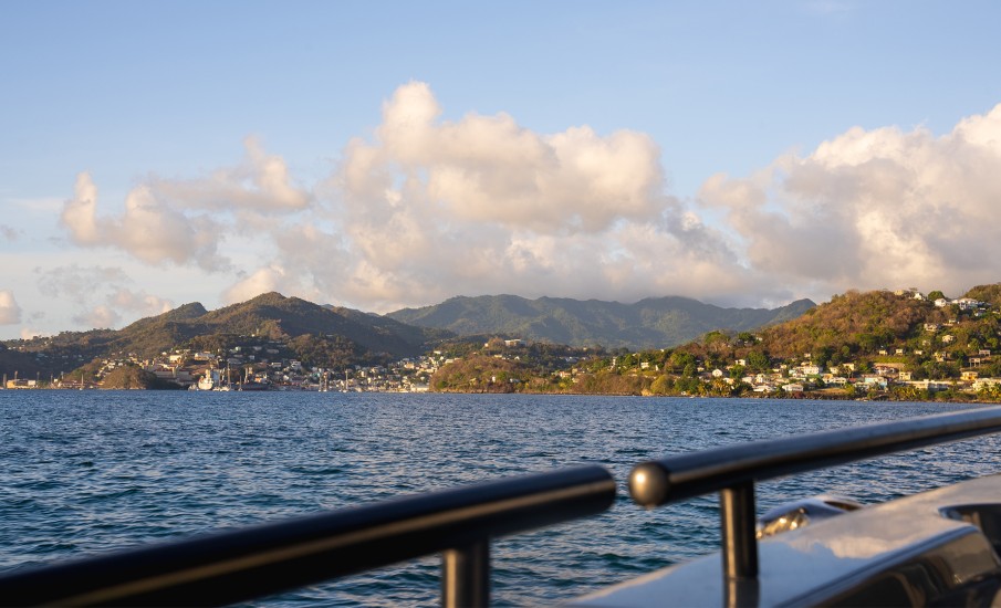 a body of water with hills and buildings in the distance