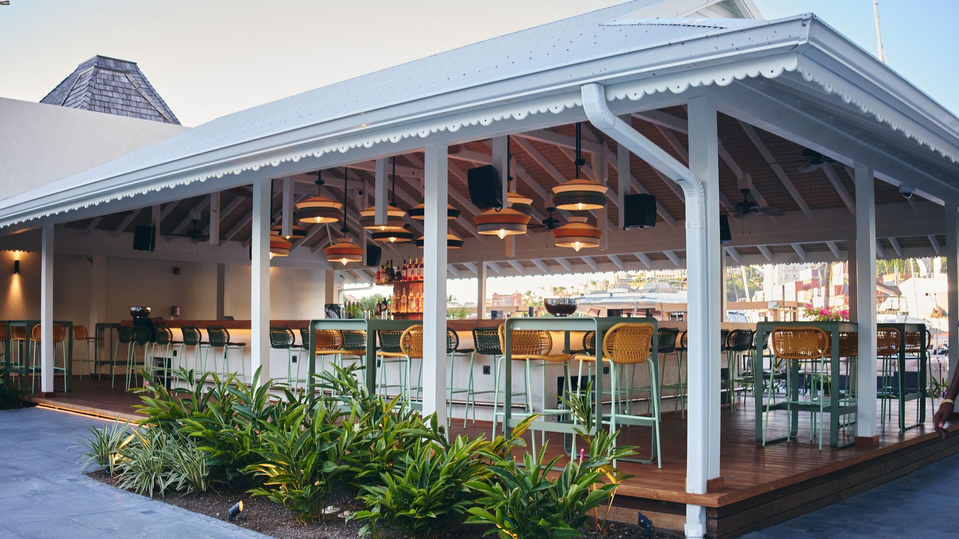a white covered patio with tables and chairs