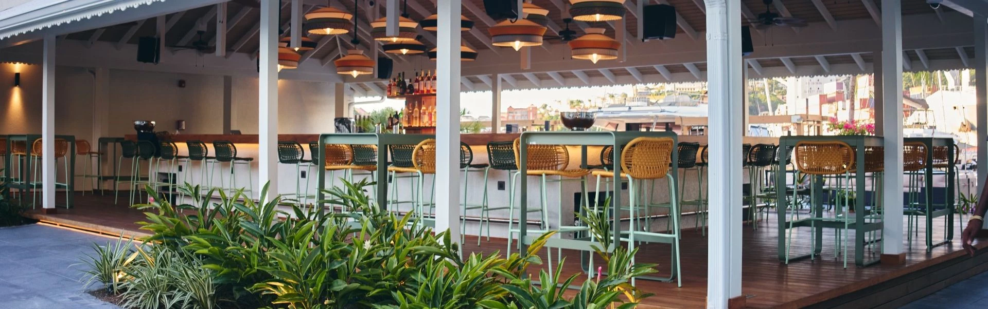 a bar with chairs and lights