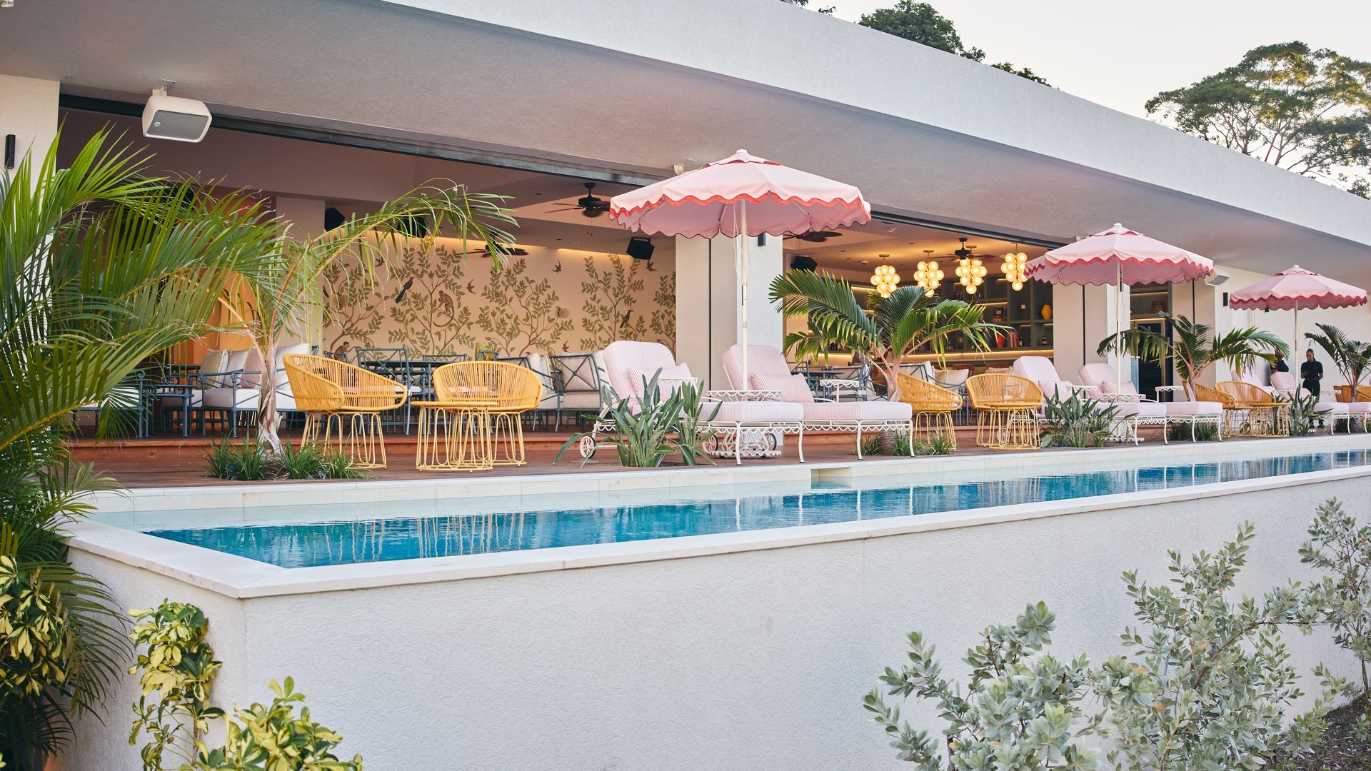 a pool with chairs and umbrellas