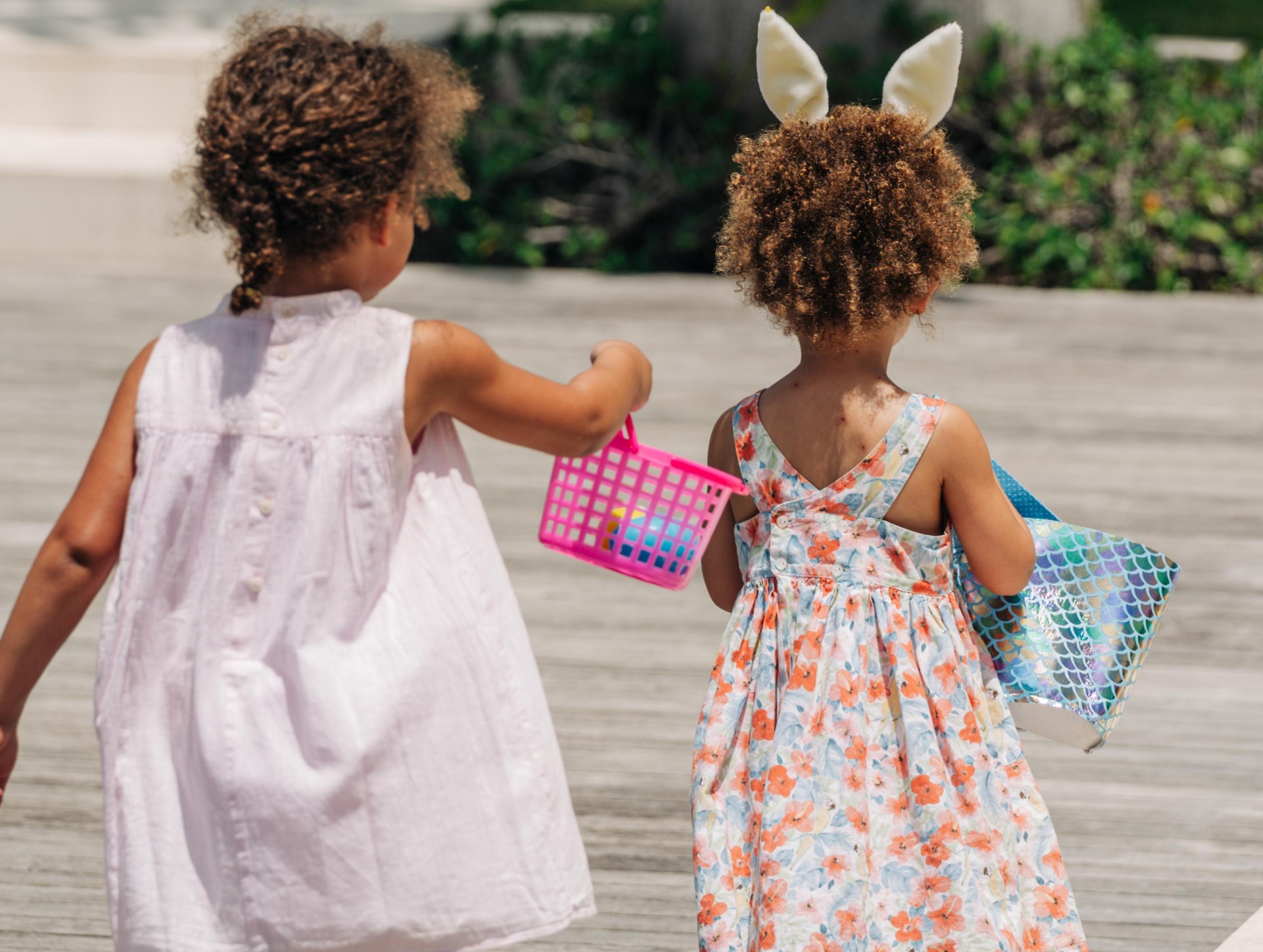two girls holding a basket and a basket with eggs