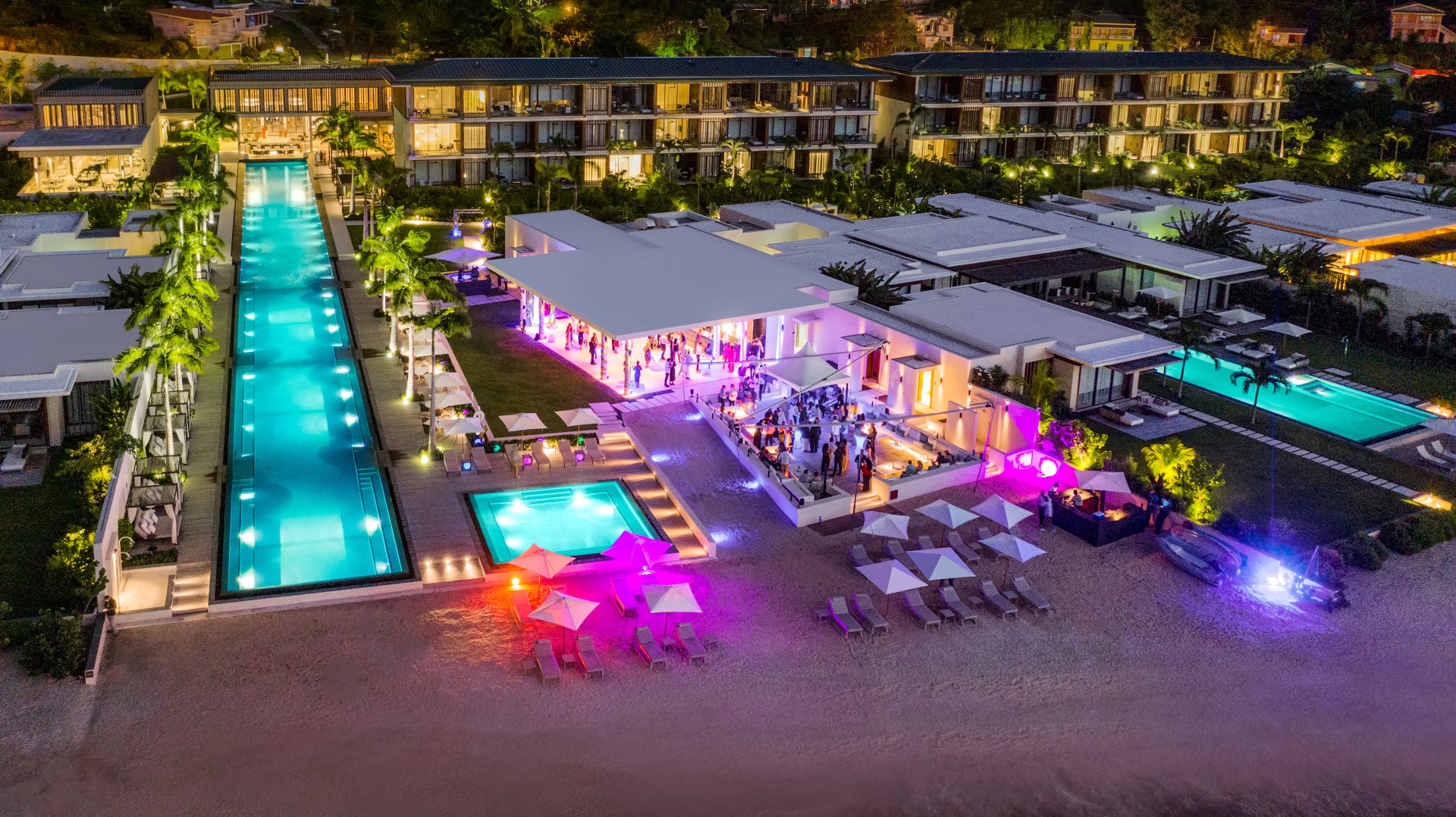 a group of people at a party by a pool