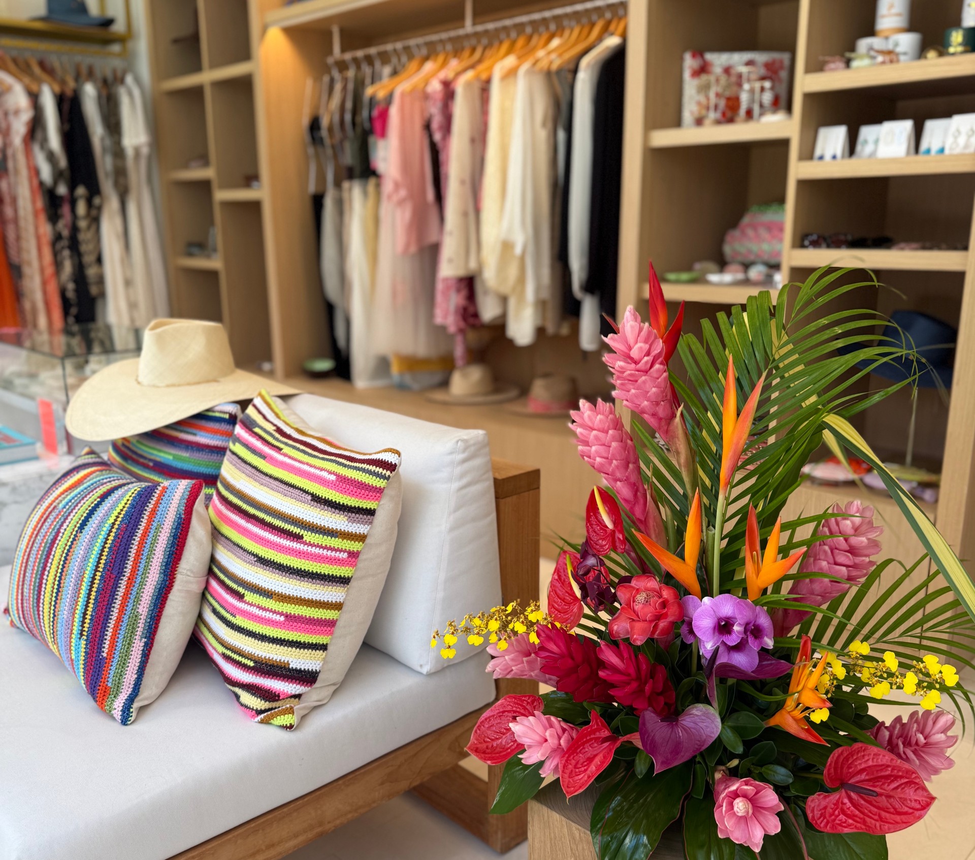 a room with a couch and a hat and flowers
