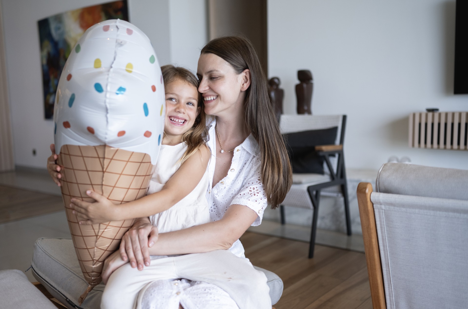 a woman and a child holding an ice cream cone