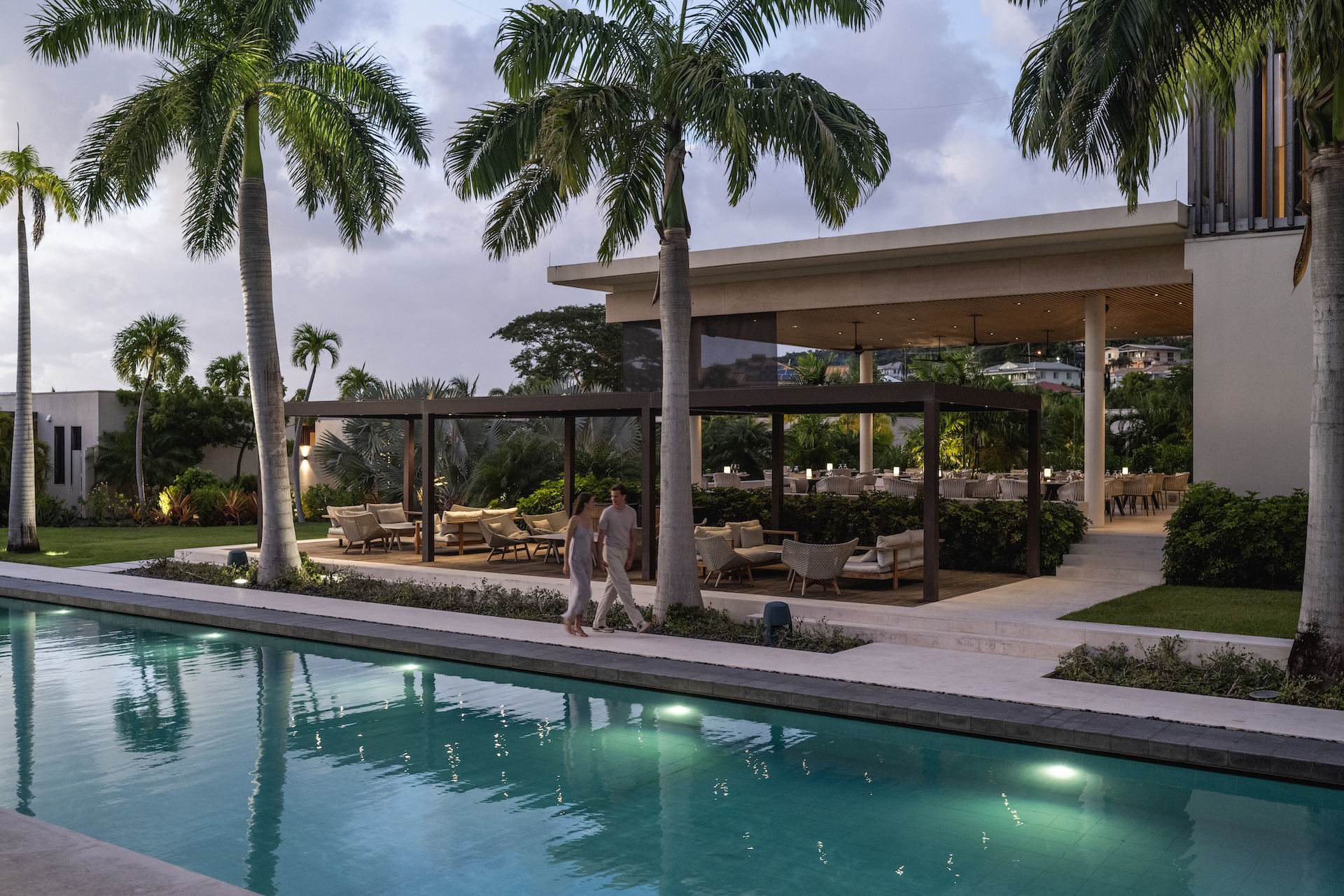 a man walking by a pool