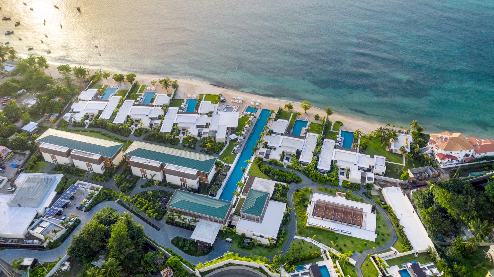 a aerial view of a resort with a pool and a beach