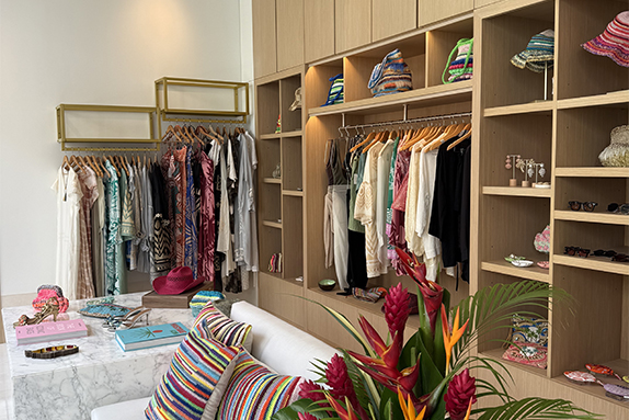 a room with shelves and clothes on swingers