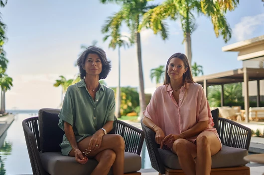 two women sitting on chairs