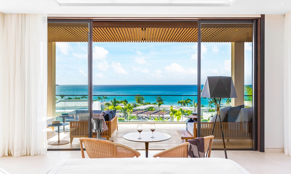 a room with a view of the ocean and a beach