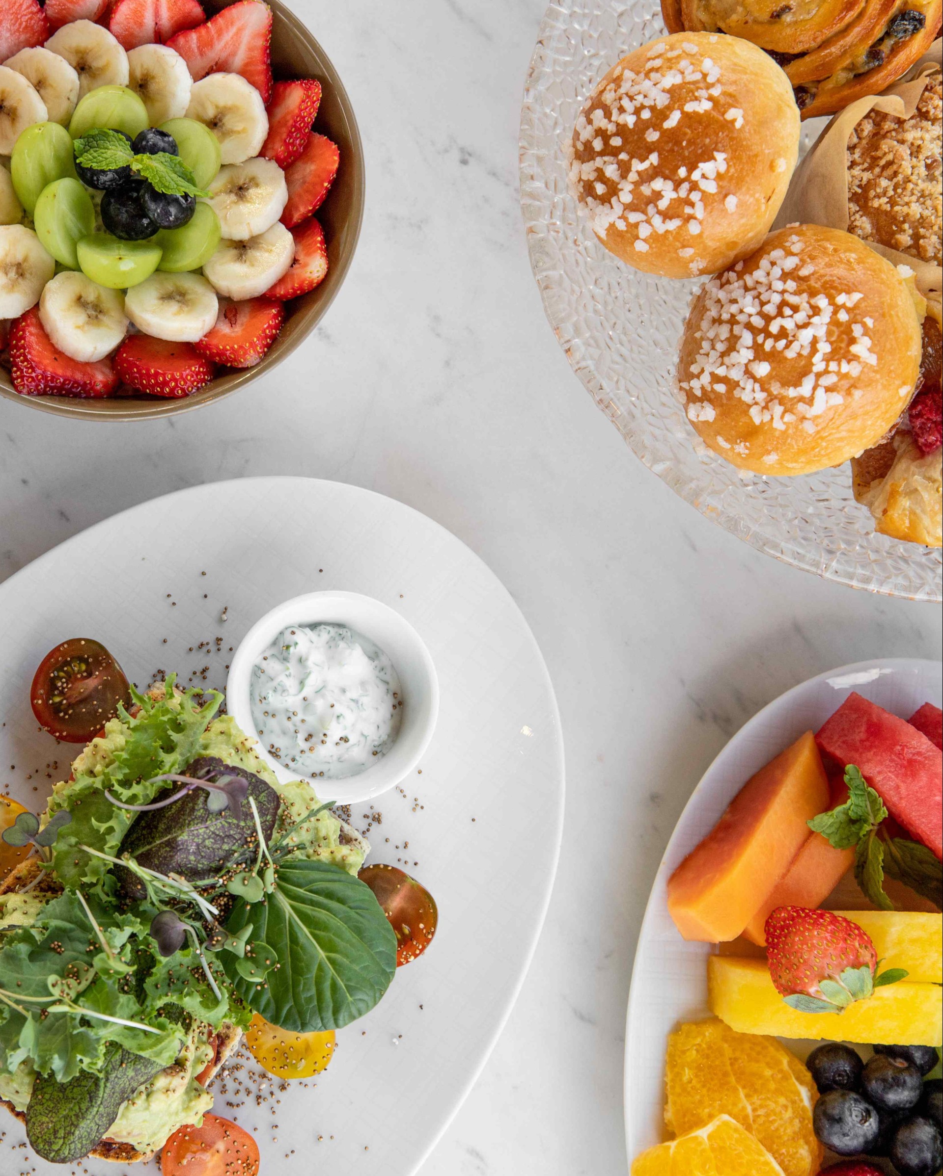 a table with plates of food and fruit