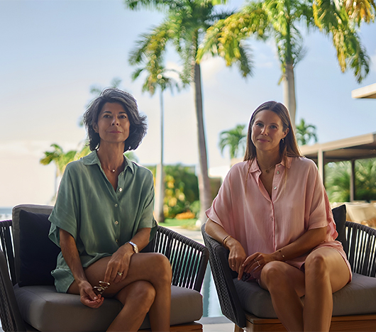 two women sitting in chairs