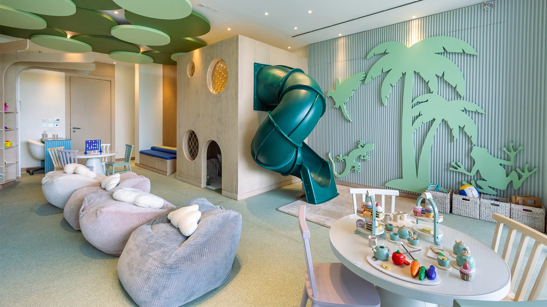 a room with a slide and a play house
