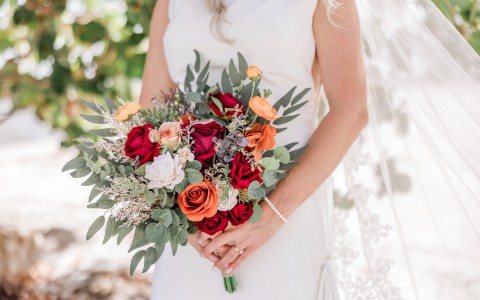 a woman in a white dress holding a bouquet of flowers