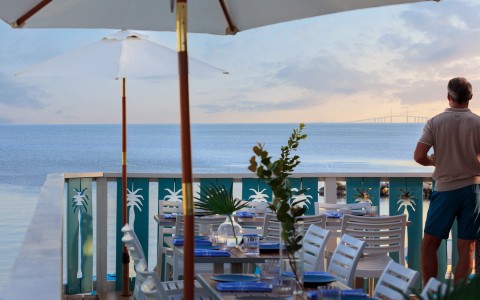 a table set up on a deck overlooking the ocean