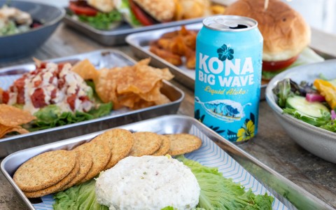 a can of soda and food on a tray