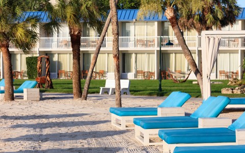 a group of lounge chairs on a beach
