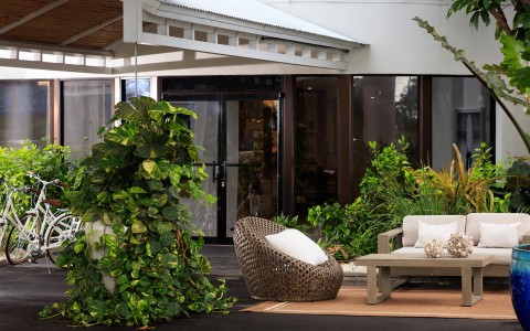 a patio with a chair and a bench