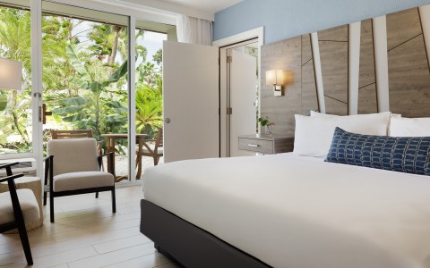 a bedroom with a bed and chairs