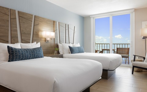 a room with two beds and a balcony