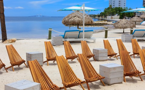 a beach with chairs and umbrellas