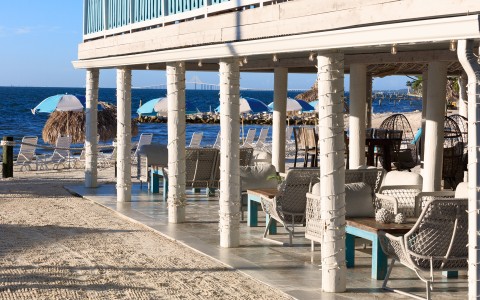 a beach with a deck and chairs