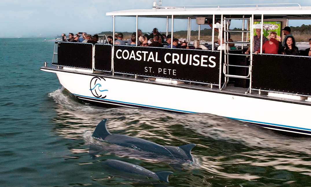 a boat with dolphins in the water