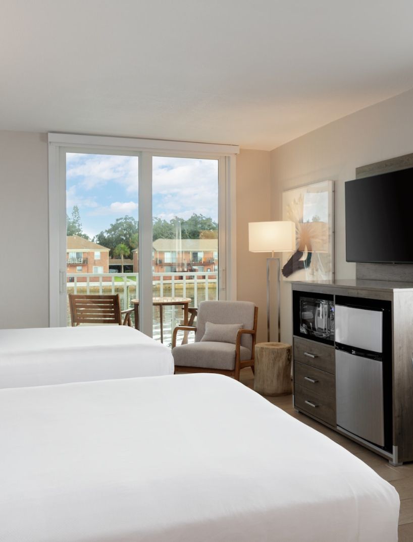 a room with two beds and a television