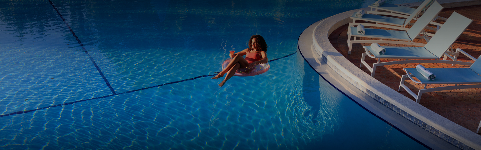 a woman in a swimsuit on a float in a pool