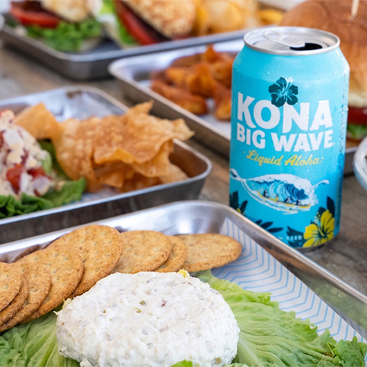 a can of soda and food on a table