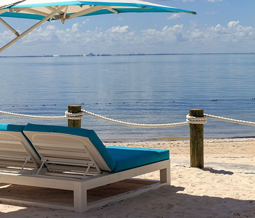 a beach chair under a umbrella