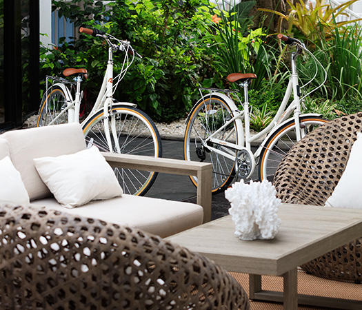 a white bicycle next to a couch and a table