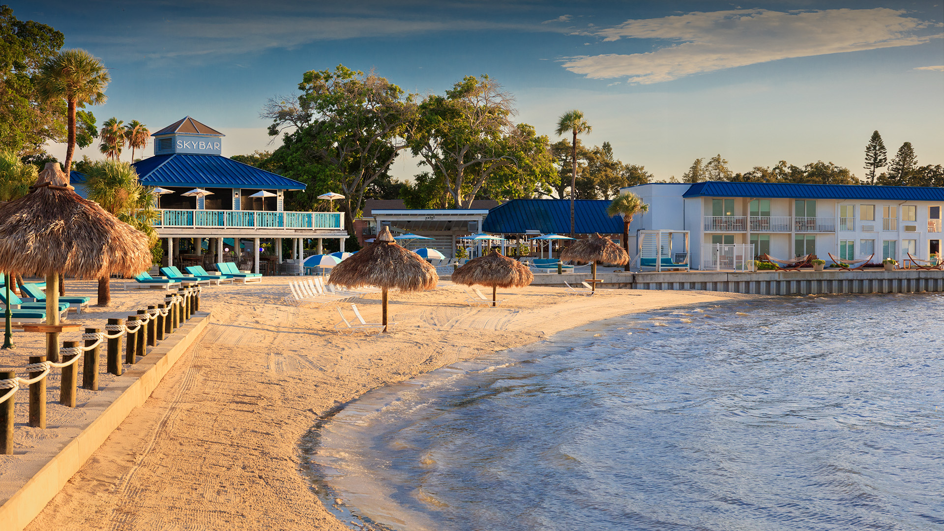 a beach with umbrellas and chairs on the sand
