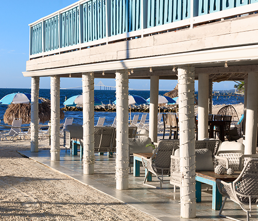 a beach with a deck and chairs