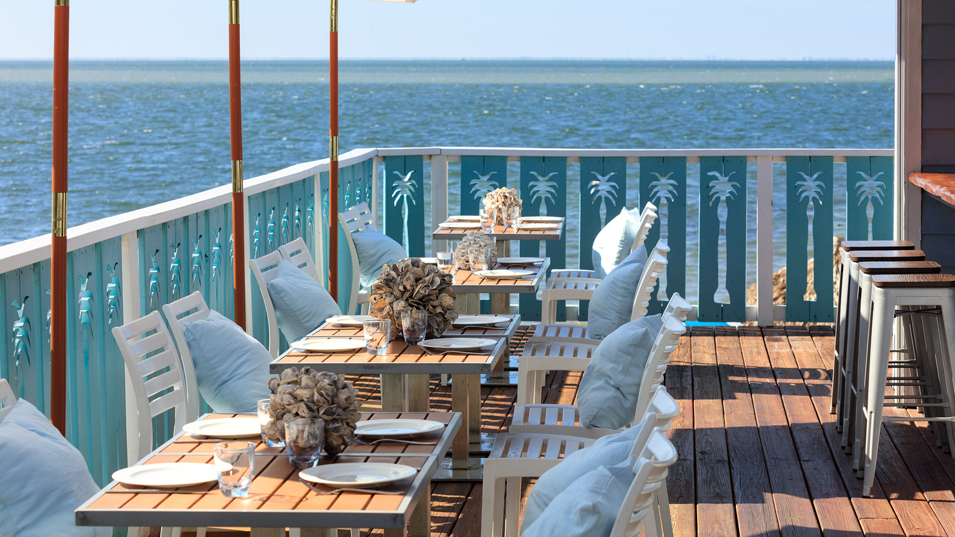 a table set up on a deck overlooking the ocean