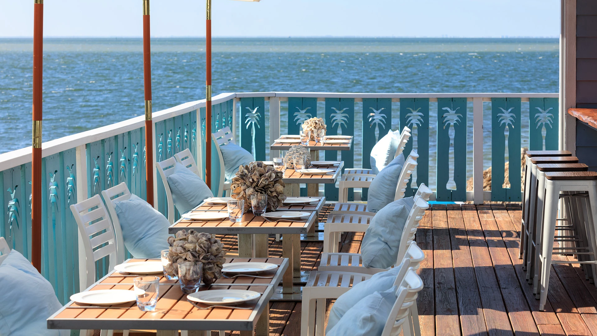 An outdoor dining area with a view of the ocean