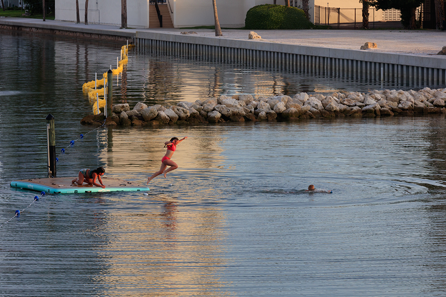 a woman jumping into the water